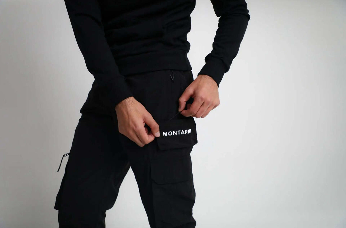 A model showcasing the Active Tactical Cargo Pants by Montarni, adjusting the pocket for a secure fit.