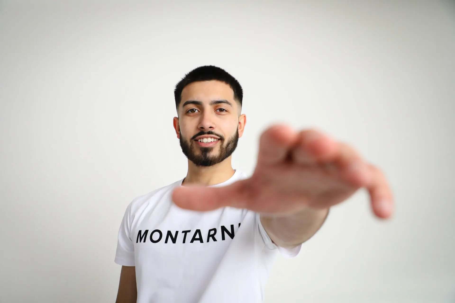 Model wearing Montarni soft cotton t shirt men in white with raised flocked logo and comfortable classic fit