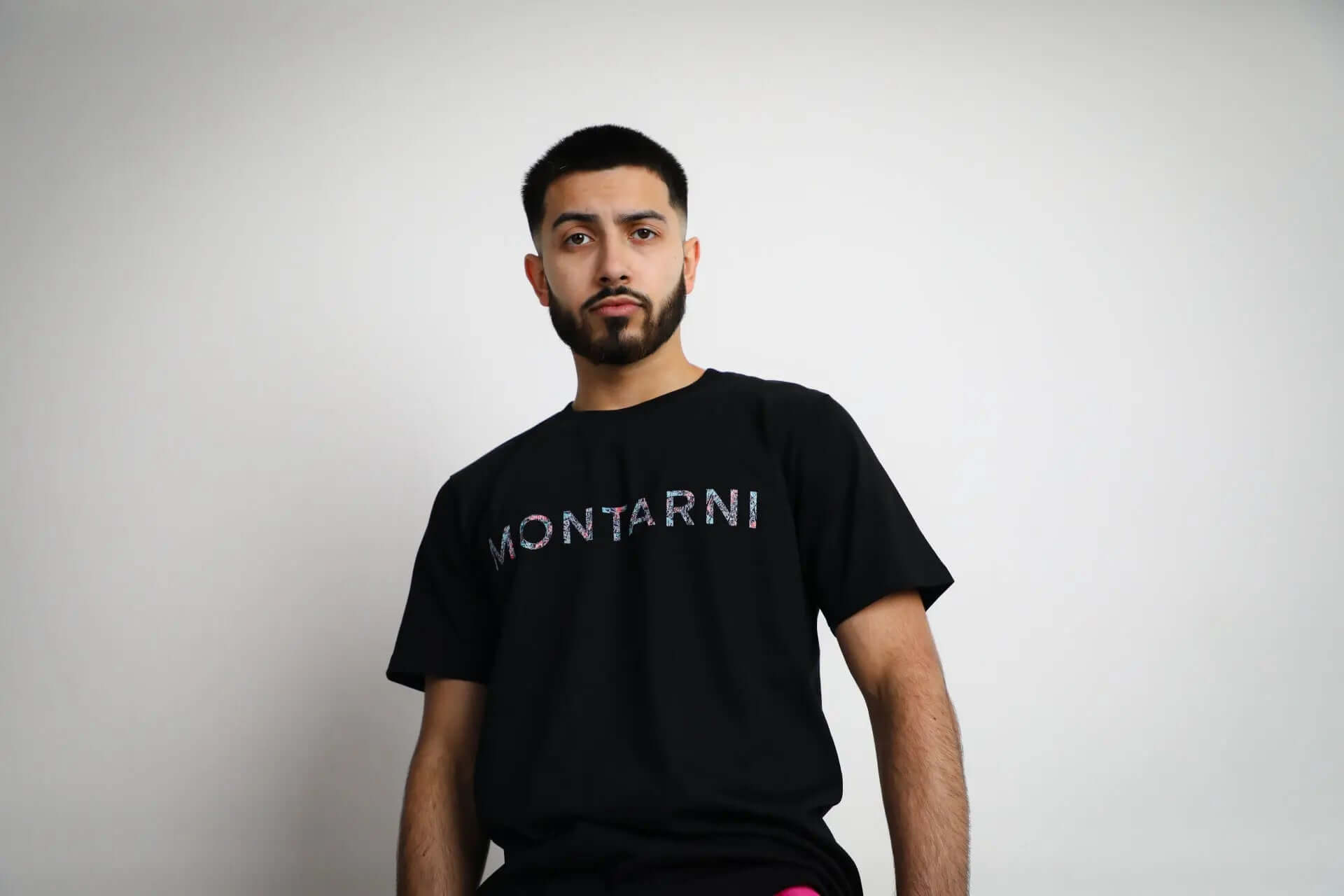 Model wearing Montarni soft cotton t-shirt in black with relaxed fit and signature front logo