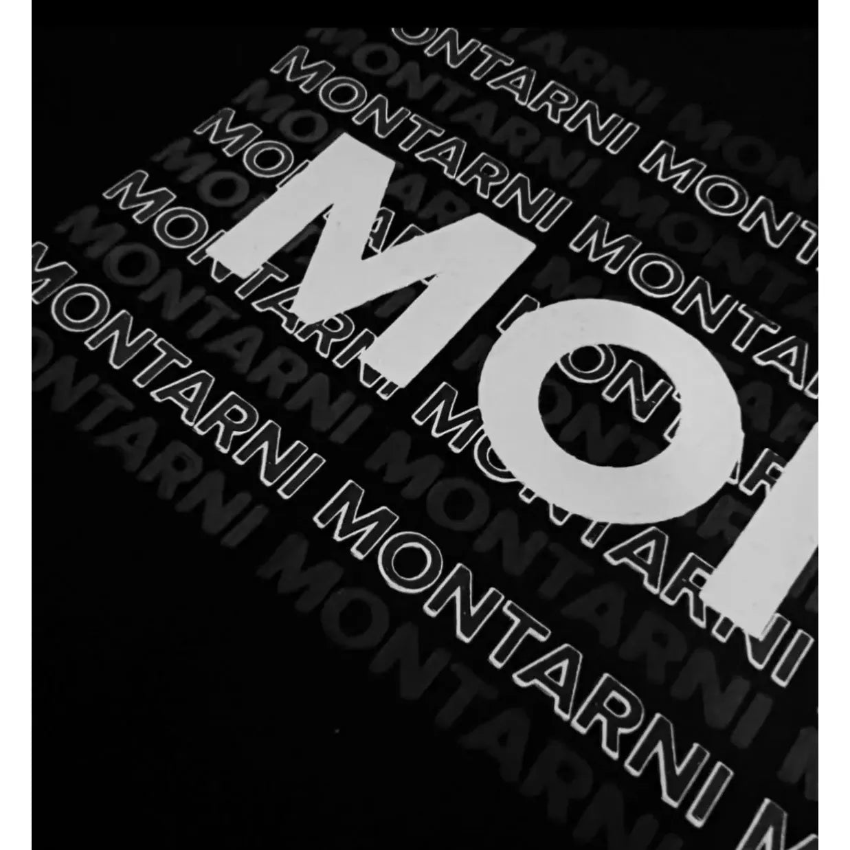 Close-up image of Montarni Monogram graphic on a soft cotton graphic t-shirt.
