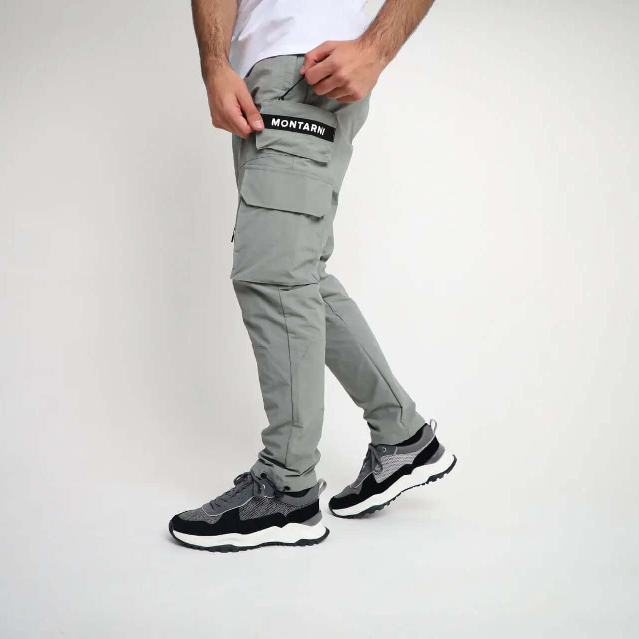 Man wearing Active Tactical Cargo Pants in Grey with Montarni branding.
