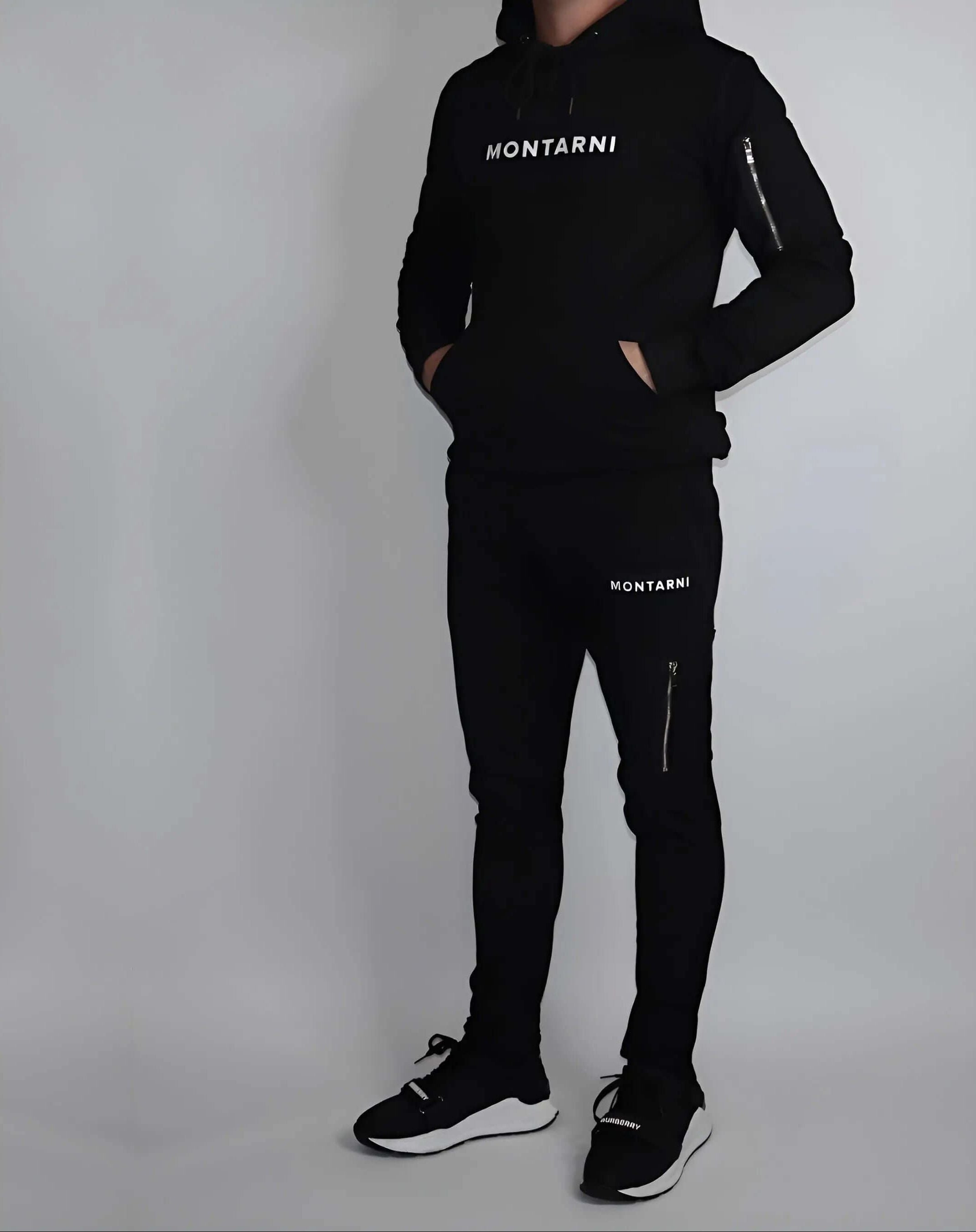 Techwear hoodie worn by a model, featuring sleek design and Montarni logo, paired with matching pants.
