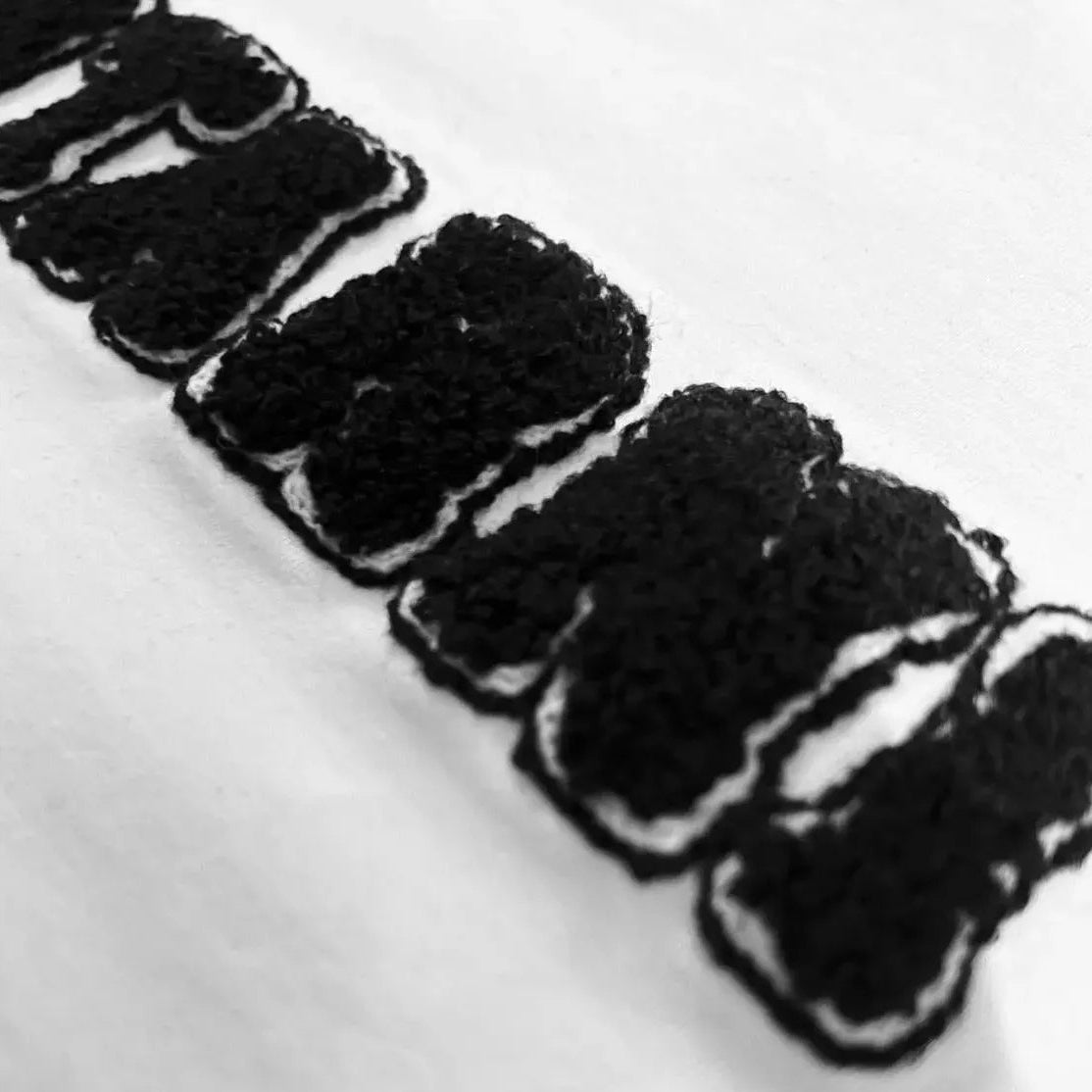 Close-up of Montarni soft cotton t-shirt men with textured chenille embroidery on chest