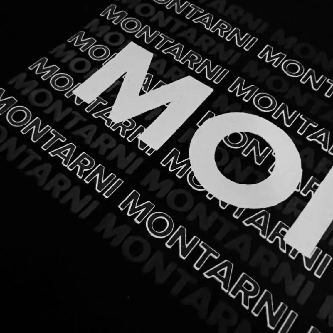 Close-up image of Montarni Monogram graphic on a soft cotton graphic t-shirt.